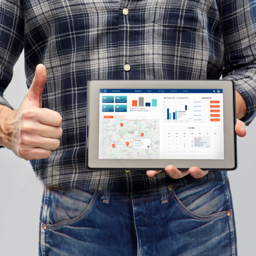 repair, construction and building - male worker or builder with working tools on belt showing tablet pc computer and thumbs up gesture over grey background